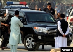 Muhammad Safdar, husband of Maryam Nawaz, daughter of ousted Pakistani premier Nawaz Sharif, waves from a a vehicle as he arrives at an accountability court in Islamabad, Oct. 19, 2017.