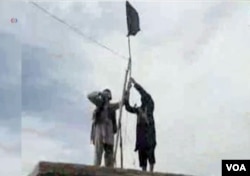 FILE- IS's Khorasan group raises a flag in a tribal region of Afghanistan, Nov. 2, 2015.
