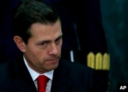 FILE - Mexico's President Enrique Pena Nieto pauses during a press conference at the Los Pinos presidential residence in Mexico City, Jan. 23, 2017.