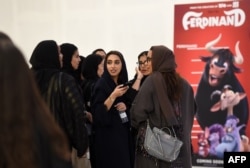 FILE - Saudi women gather at a cinema theater in Riyadh Park mall after its opening for the general public, April 30, 2018.
