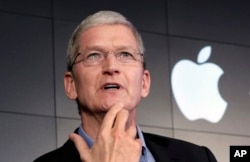 FILE - Apple CEO Tim Cook responds to a question during a news conference at IBM Watson headquarters, in New York, April 30, 2015. Cook says his company will not comply with a judge's ruling calling on Apple to help the FBI gain access to a locked iPhone.