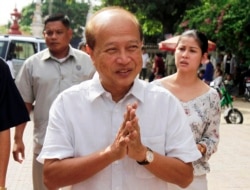 FILE - In this Sunday, June 3, 2012, Cambodian Prince Norodom Ranariddh greets people before casting his ballot in local elections at the Wat Than temple in Phnom Penh, Cambodia. (AP Photo)
