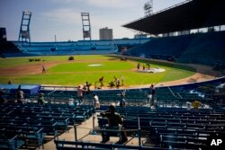 People work near a statue of Cuban baseball fan and entertainer Armando Luis Torres Torres at the Latinoamericano stadium, March 16, 2016. The Cuban national team and the Tampa Bay Rays will play a friendly game March 22 in Havana.