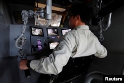 Sakakibara Kikai's engineer Masaaki Nagumo controls the bipedal robot Mononofu from its cockpit