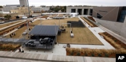 Work crews rush to set up a stage beside the state's two newest museums, the Museum of Mississippi History and the Mississippi Civil Rights Museum, Dec. 7, 2017, in Jackson, Mississippi.