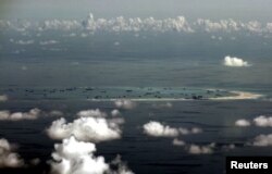 FILE - An aerial photo taken from a Philippine military plane shows reclamation activities by China on Mischief Reef in the Spratly Islands in the South China Sea, west of Palawan, Philippines, May 11, 2015.