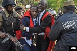 Students of Makerere University clash with police officers during a protest against the official procedure to scrap a presidential age limit from the constitution in Kampala on Sept. 21, 2017.