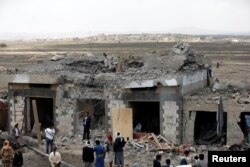 FILE - People gather at the site of Saudi-led air strikes in Arhab area, around 20 kilometres (13 miles) north of Sana'a, Aug. 23, 2017.