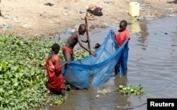FILE - Children use a mosquito net to fish along the Nile river in South Sudan's capital of Juba, Jan. 8, 2011.