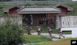 FILE - In this Sept. 19, 2017, photo, U.S. Army soldiers from the 2nd Infantry Division's 2nd Armored Brigade Combat Team move during a joint military exercise between the U.S. and South Korea in Pocheon, South Korea. A South Korean lawmaker said Oct. 10, 2017, that North Korean hackers may have stolen highly classified military documents that include U.S.-South Korean wartime "decapitation strike" plans against the North, according to South Korean media reports.