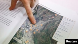 Sarah Son, research director of Transitional Justice Working Group, points at a map containing information on important facilities in the North Korea border city of Hyesan, during an interview in Seoul, South Korea, July 19, 2017.