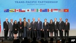 Trade delegates appear after signing the Trans-Pacific Partnership agreement in Auckland, New Zealand in February.
