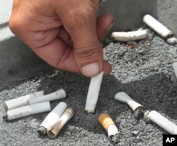 FILE - A smoker snuffs out a cigarette at the Capitol in Sacramento, Calif., June 22, 2012.