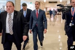 Former Trump campaign manager Cory Lewandowski, center, and his lawyer Peter Chavkin, second from left, arrive to meet behind closed doors with the House Intelligence Committee, at the Capitol in Washington, March 8, 2018.