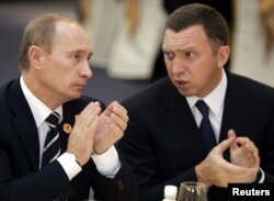 FILE - Russian President Vladimir Putin, left, and metals mogul Oleg Deripaska attend a meeting of members of the APEC business consultative council in Hanoi, Nov. 18, 2006.