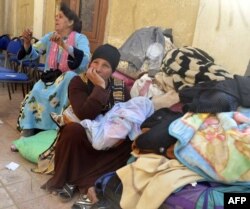Egyptian Coptic Christians sit in the courtyard of the Evangelical Church in the Suez Canal city of Ismailia, Feb. 24, 2017, upon arriving to take refuge from Islamic State jihadists.