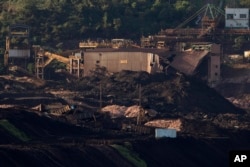 A destroyed facility and wagons stand in ruins after a dam collapsed two days prior, next to dam B6 that was at risk of breaching as well, in Brumadinho, Brazil, Jan. 27, 2019.
