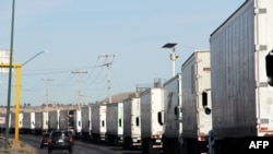 Cargo trucks lineup to cross to the United States near the US-Mexico border at the Cordova-Americas International Bridge in Ciudad Juarez, Chihuahua state, Mexico, April 4, 2019. 