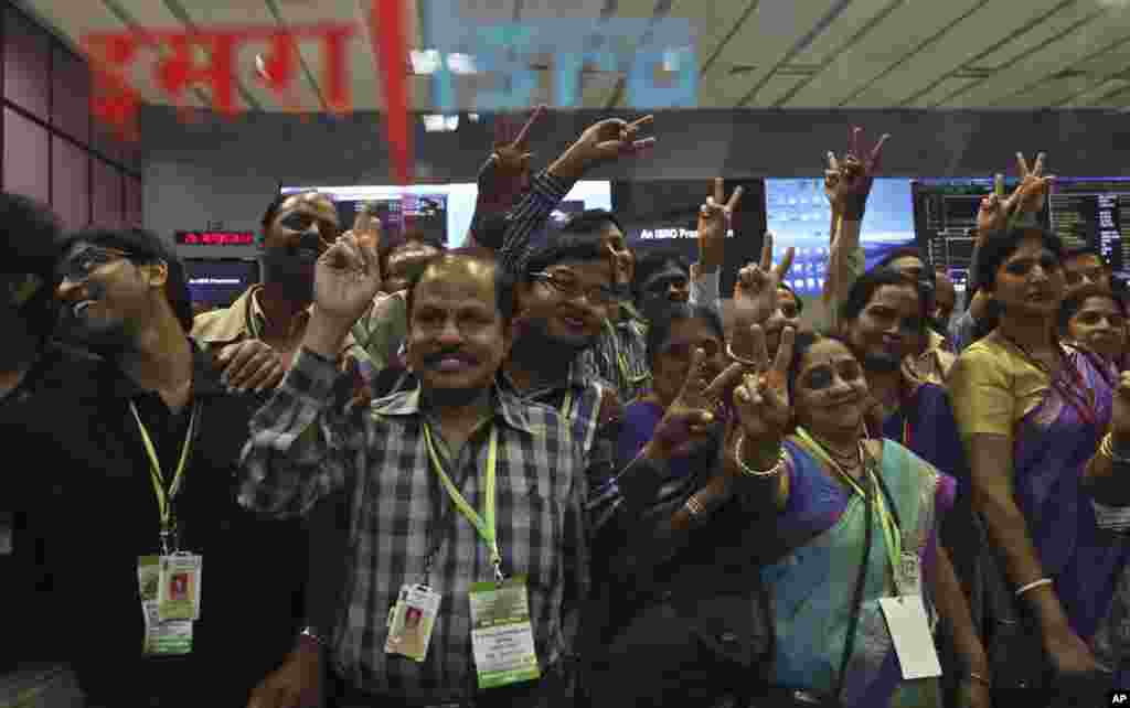 Indian Space Research Organization scientists and other officials celebrate the success of Mars Orbiter Mission at their Telemetry, Tracking and Command Network complex in Bangalore, India, Sept. 24, 2014.