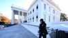 FILE - A Secret Service agent walks near the north portico of the White House on Dec. 2, 2024. 