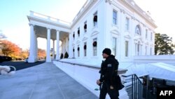 FILE - A Secret Service agent walks near the north portico of the White House on Dec. 2, 2024. 