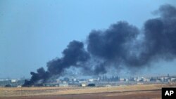  In this photo taken from the Turkish side of the border between Turkey and Syria, in Akcakale, Sanliurfa province, southeastern Turkey, smoke billows from a fire inside Syria during bombardment by Turkish forces Wednesday, Oct. 9, 2019. 