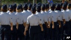 In this June 22, 2012, image taken from video, female airmen march during graduation at Lackland Air Force Base in San Antonio, Texas..