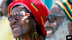 FILE - Deborah Smith and her husband, Kuma, watch festivities at a Juneteenth celebration in Los Angeles, June 19, 2010.