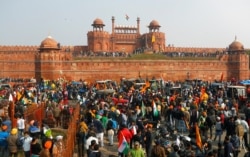 Farmers gather in front of the historic Red Fort during a protest against farm laws introduced by the government, in Delhi, India, Jan. 26, 2021.