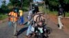 FILE - Armed anti-balaka militiamen guard a checkpoint about 60 kilometers north of Bangui, Central African Republic, June 2014.