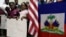 FILE – Standing near U.S. and Haitian flags, youngsters advocate for renewing Temporary Protected Status (TPS) for Central American and Haitian immigrants, at a news conference in Miami, Fla., Nov. 6, 2017.