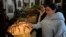 FILE - A Syrian Christian woman lights a candle during the first Sunday Mass since Syrian President Bashar al-Assad's ouster, at Mariamiya Orthodox Church in Old Damascus, Syria, Dec. 15, 2024.