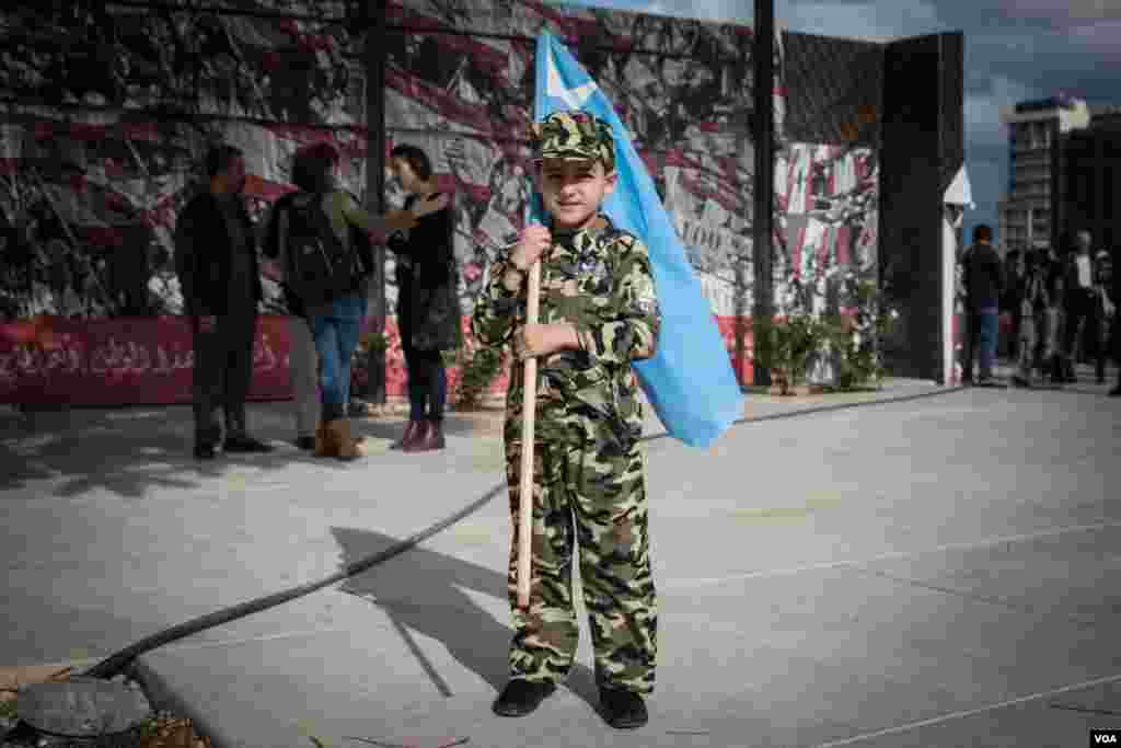 A young boy holds the flag for Prime Minister Saad Hariri's party, the Future Movement, in Beirut, Lebanon, Nov. 22, 2017.