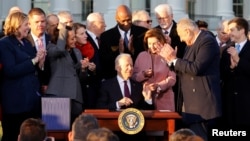 U.S. President Joe Biden reacts as he signs the "Infrastructure Investment and Jobs Act", on the South Lawn at the White House in Washington, U.S., November 15, 2021. (REUTERS/Jonathan Ernst)