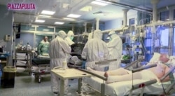 Medical staff in protective suits treat coronavirus patients in an intensive care unit at the Cremona hospital in northern Italy, in this still image taken from a video, March 5, 2020.