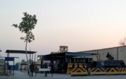 FILE - Security and police vehicles guard Cairo's Tora prison, in Cairo, Egypt, June 17, 2019.