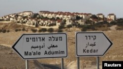 The West Bank Jewish settlement of Maale Adumim, near Jerusalem, is seen behind sign posts December 3, 2012. 