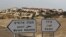 The West Bank Jewish settlement of Maale Adumim, near Jerusalem, is seen behind sign posts December 3, 2012. 
