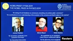 A screen displays the portraits of the laureates of the 2019 Nobel Prize in Physics (L-R) James Peebles, Michel Mayor and Didier Queloz, during a news conference at the Royal Swedish Academy of Sciences in Stockholm, Sweden, October 8, 2019