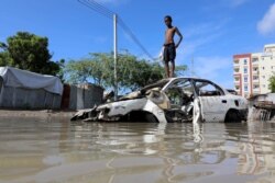 A Somali boy stands on a junk vehicle after heavy rain flooded their neighbourhood in Mogadishu, Somalia October 21, 2019.