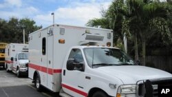 These ambulances, parked behind Notre Dame d'Haiti's school yard, were donated to Haiti by the city of Chicago
