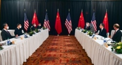 FILE - U.S. Secretary of State Antony Blinken, second right, and Chinese Foreign Minister Wang Yi, left, lead their delegations in U.S.-China talks in Anchorage, Alaska, March 18, 2021.