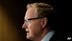 FILE - Reserve Bank Gov. Philip Lowe outlines measures the bank will take to support an economy rocked by international travel restrictions, bans on large public gatherings and escalating unemployment, in Sydney, March 19, 2020.