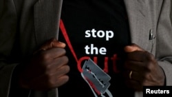 FILE - A man's T-shirt reads "Stop the Cut" referring to Female Genital Mutilation during a social event advocating against such harmful practices at the Imbirikani Girls High School in Imbirikani, Kenya, April 21, 2016.