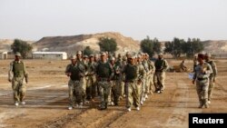 Iraqi tribal fighters take part in a military training to prepare for fighting against Islamic State militants, at the Ain al-Assad military base in Anbar province, Nov. 15, 2014.
