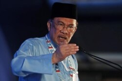 FILE - President of the People’s Justice Party Anwar Ibrahim gives the keynote address during their general assembly in Melaka, Malaysia, Dec. 7, 2019.