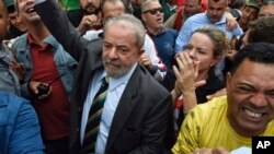 L'ancien président brésilien Luiz Inácio Lula da Silva, centre gauche, est salué par les supporters alors qu'il arrive au bâtiment de la Justice fédérale à Curitiba, au Brésil, le 10 mai 2017.