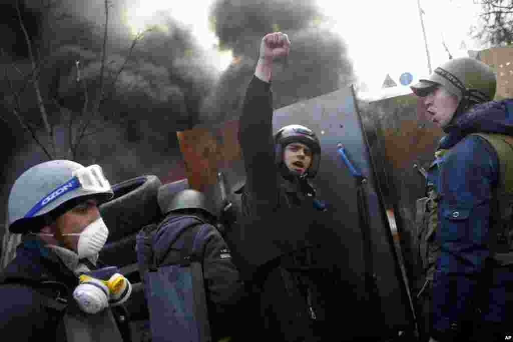 Anti-government protesters shout "Glory to the Ukraine" as they man a barricade at Independence Square in Kyiv, Feb. 21, 2014.