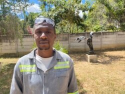 Forty-year-old Zimbabwean sculptor David Ngwerume in front of his exhibit, called “Arms,” in what he calls a “COVID-19 Gallery” in Harare, April 23, 2021. (VOA/Columbus Mavhunga)