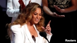 FILE - Beyonce reacts after winning the entertainer of the year award, 50th NAACP Image Awards, Los Angeles, California, March 30, 2019.